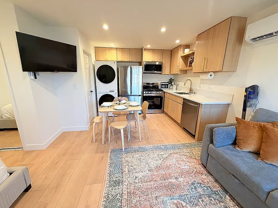 Finished studio ADU interior with full kitchen, dining, and lounge