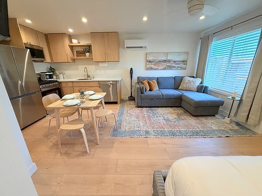 Open studio showing the king bed, sofa, dining table, and kitchen at the Anaheim ADU (photo 5)